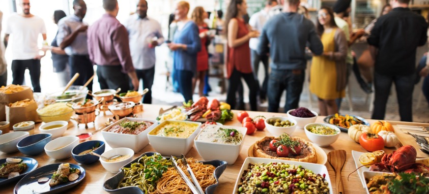 A catering table full of food from a variety of cultures