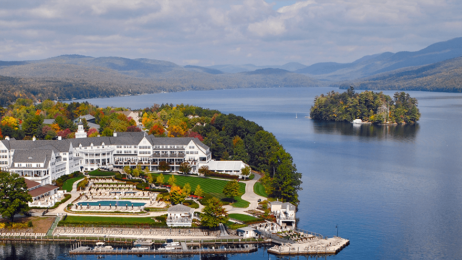 An aerial view of Sagamore Resort in the Lake George area. The resort is on an island with fall trees on the lake.