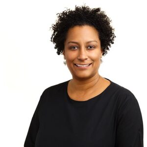 A portrait of Melissa Cherry. She is a black woman with short natural hair and a black blouse