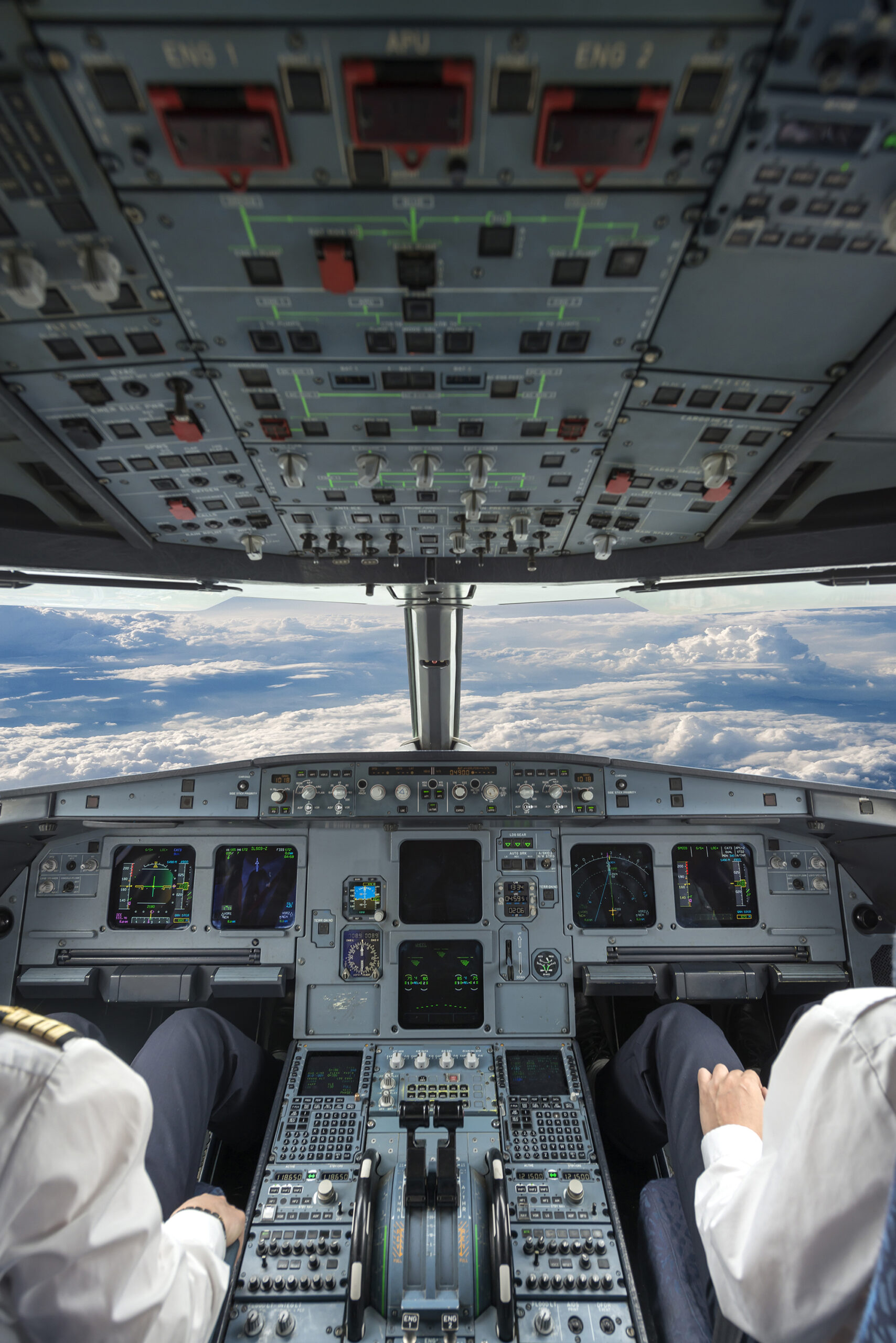 The interior of a plane's cockpit looking over rolling hills