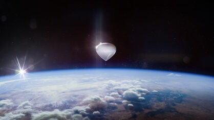 A white, walnut-shaped pod floats in Earth's atmosphere
