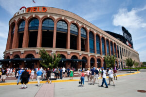 A street view of Citi Field in New York. Brick arches run around the outside