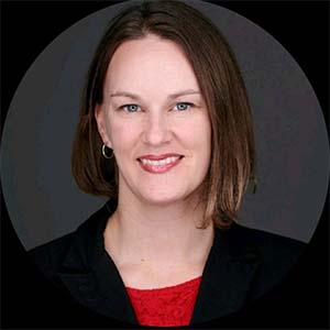 A portrait of Melinda Mintz. She is a white woman with shoulder-length brown hair and a black suit jacket.