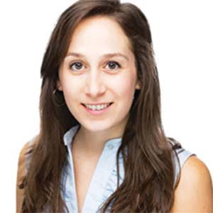 A portrait of Rachel Klar. She is a white woman with long brown hair and a sleeveless white blouse