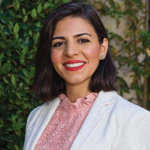 A portrait of Sepideh Eivazi. She is a South Asian woman with shoulder-length black hair and a white suit jacket