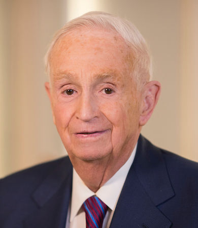 A portrait of J. W. Marriott, Jr. He is an old white man with combed white hair and a blue suit