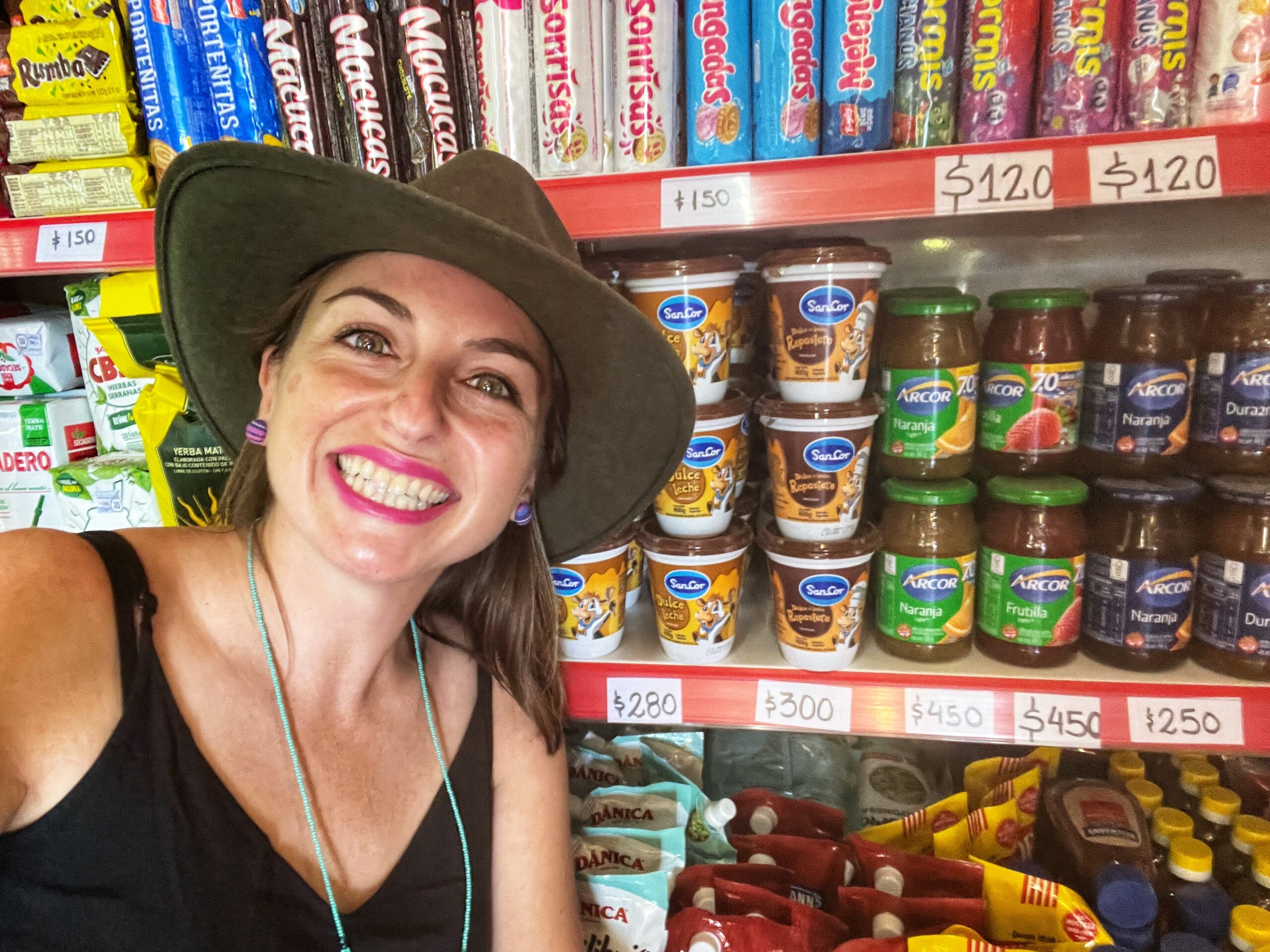 Ashley Lawson posing in front of a supermarket shelf with jams and candies
