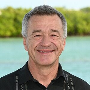 A portrait of Albert Bilotti. He is an older white man with combed greying hair and a bowling shirt