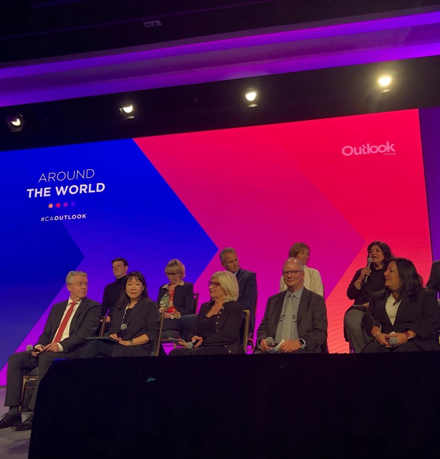 A group of global travel executives sitting on a stage