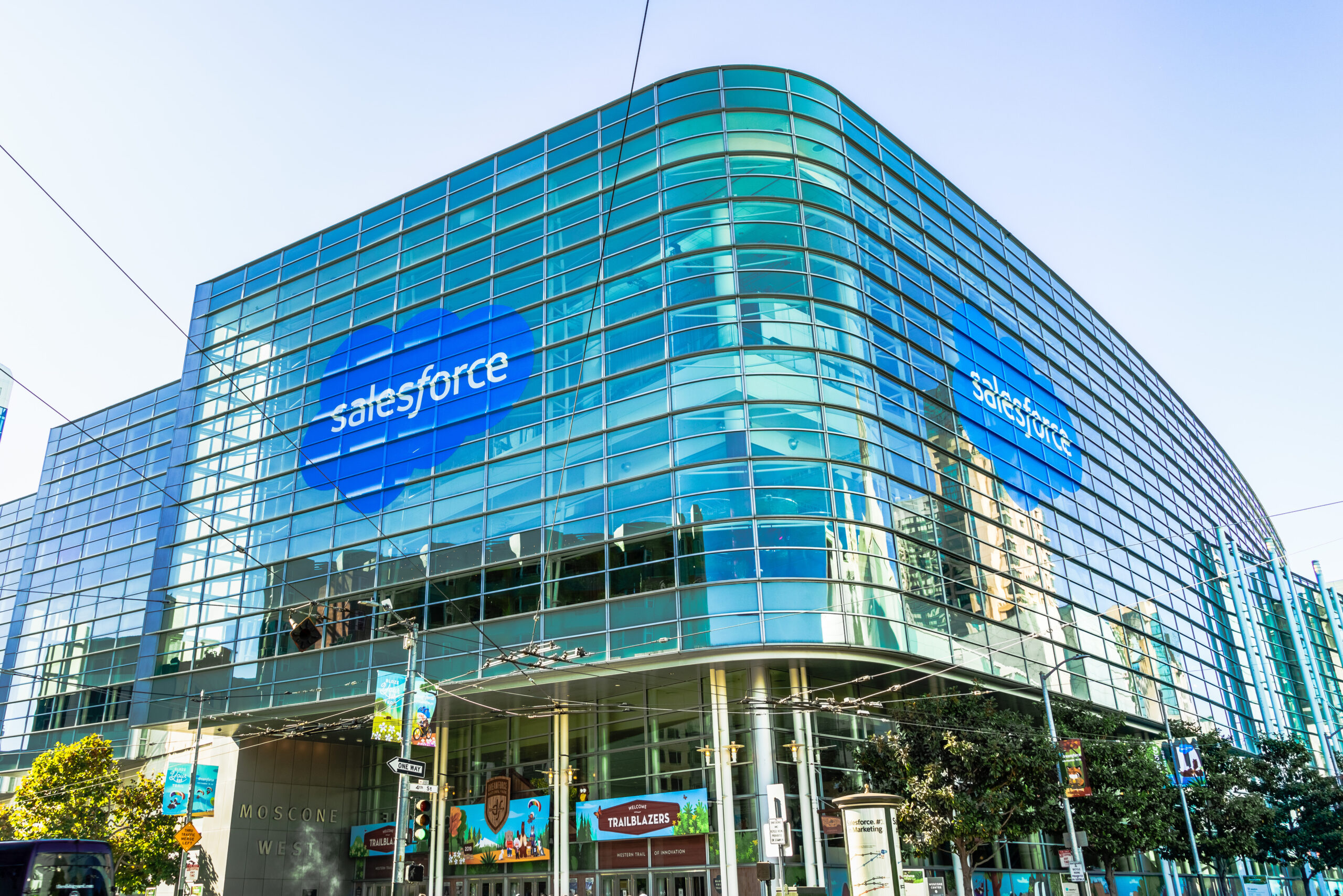 A fully windowed office building, the Moscone Center in San Francisco. The Salesforce logo is on two sides.