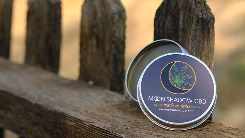 A container of CBD balm by the brand "Moon Shadow CBD"