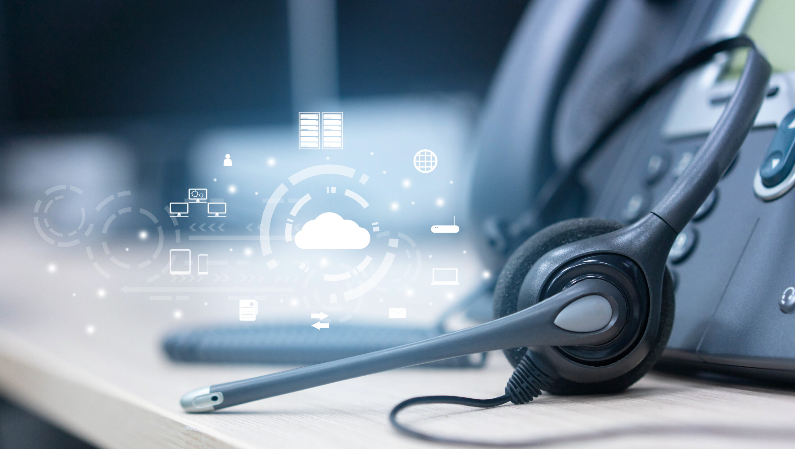 A stock photo of a headset and microphone next to a phone