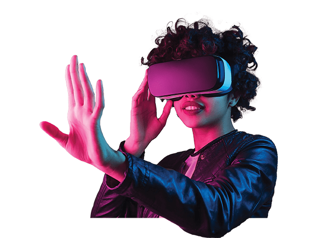 A woman with dark curly hair and a leather jacket wears a VR headset. She is holding one arm outstretched. The virtual world may be the next step in meetings.