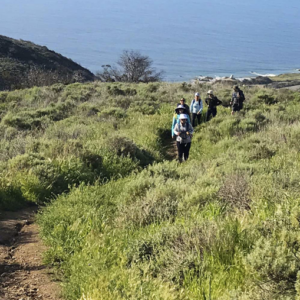 A group of hikers walking a trail at The Ranch Malibu. This is an easy way to practice sustainable tourism