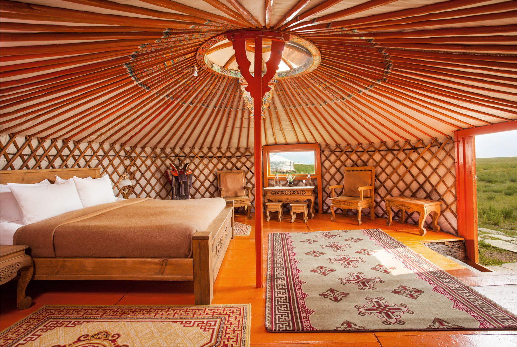 The red interior of a yurt, a type of tent, in Three Camel Lodge. The lodge rigorously practices sustainable tourism