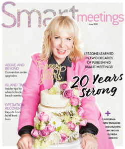 The Smart Meetings June 2022 magazine cover, featuring Marin Bright wearing a bright pink suit jacket behind a cake covered in flowers.
