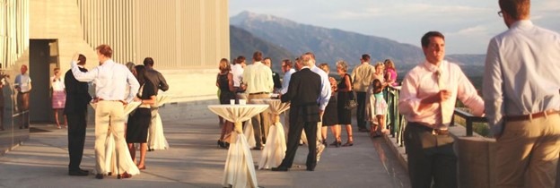 An outdoor professional gathering. A series of hills are in the distance.
