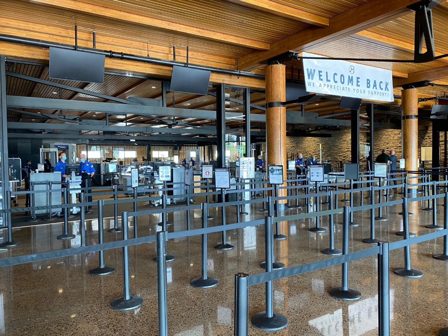 A series of stanchions under a wooden ceiling at Jackson Hole Airport.
