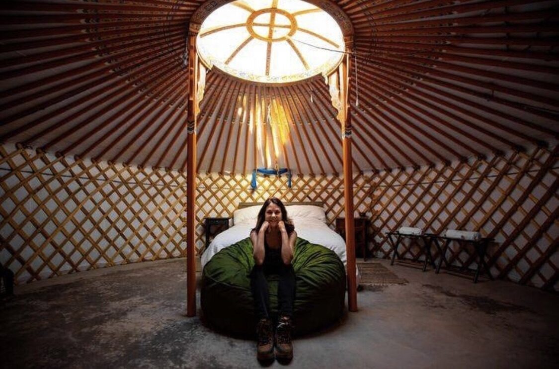 Owner Erin Stevenson sits on a bed in one of her yurts.