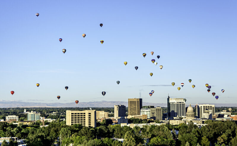 balloons floating over buildings in boise, idaho