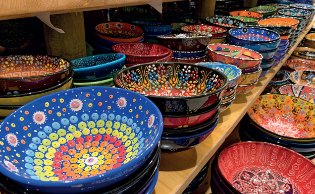 A row of colorfully decorated ceramic bowls