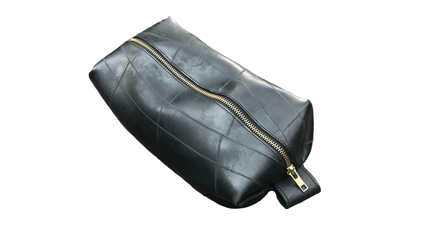 A black makeup bag made of recycled materials featured in Smart Style