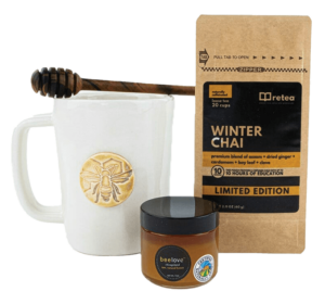 A tea kit including a mug, Winter Chai tea and a jar of honey