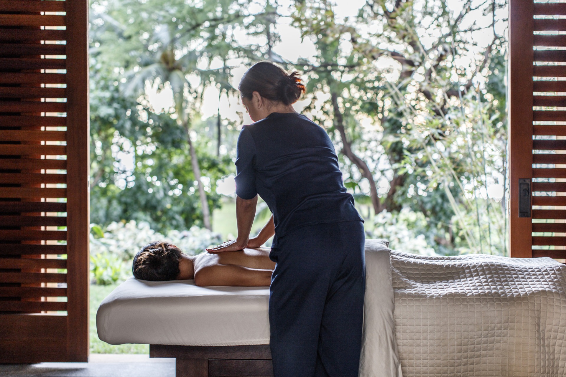 woman giving another woman a massage at Four Seasons Resort Oahu at Ko Olina Spa
