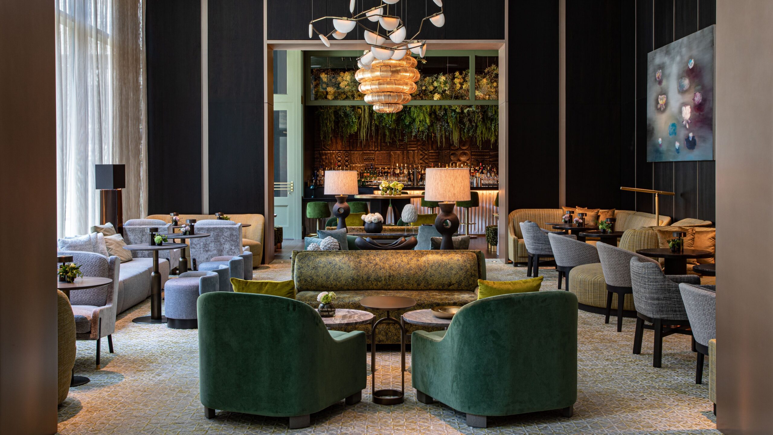 The lobby of The Ritz-Carlton New York, NoMad. The walls and furniture are dark green and black
