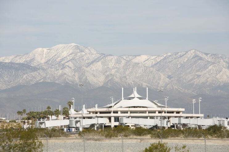 Exterior of palm springs international airport with San Bernardino Mountains and wind turbines in background