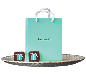 blue-green tiffany & co bag and two pieces of chocolate
