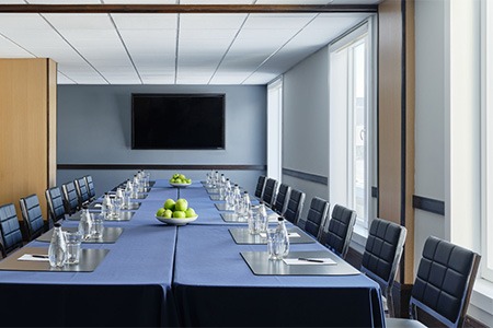 meeting space with blue clothed table and blue chairs