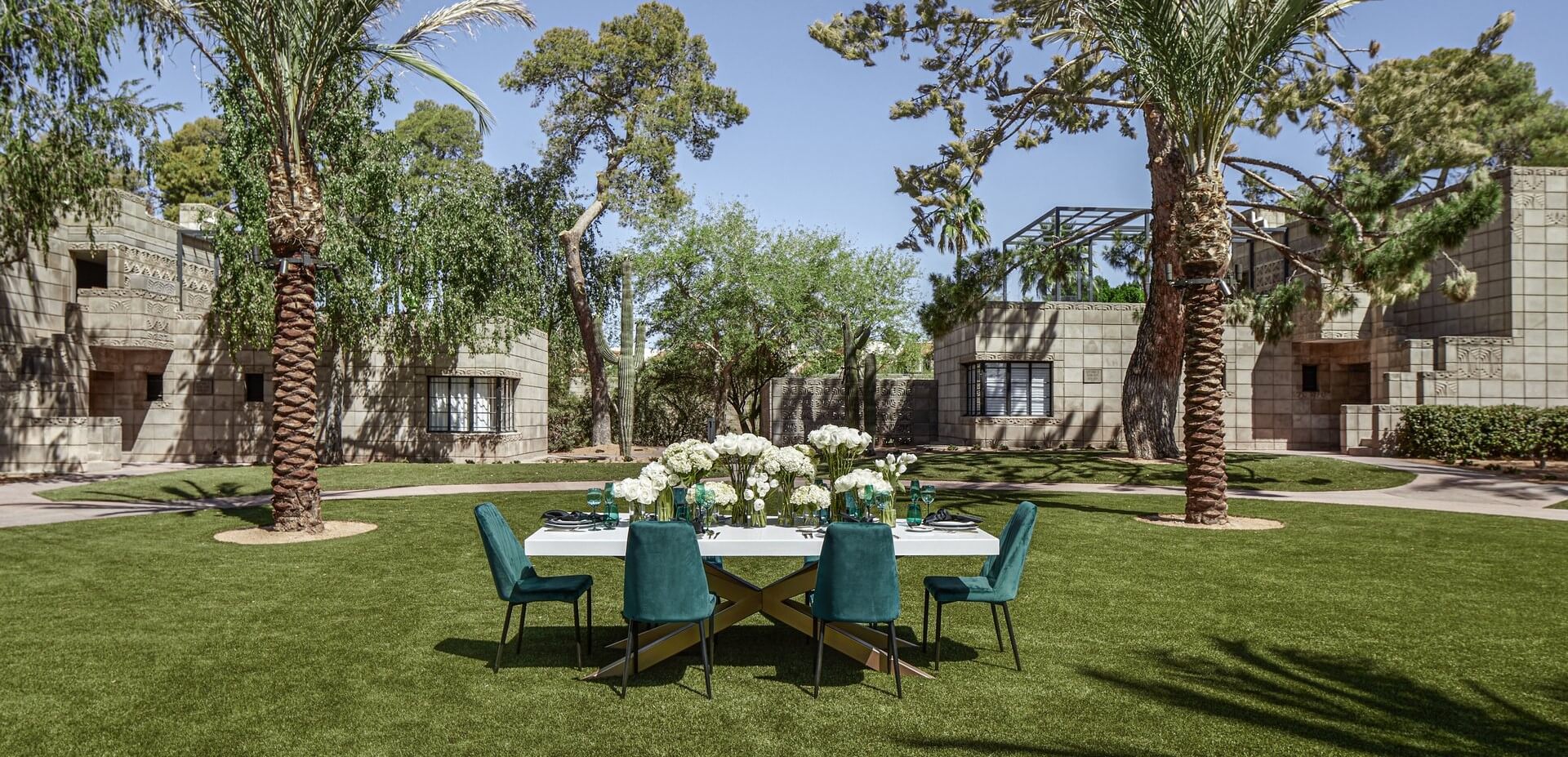 white table and six dark green chairs in outdoor space at Arizona Biltmore