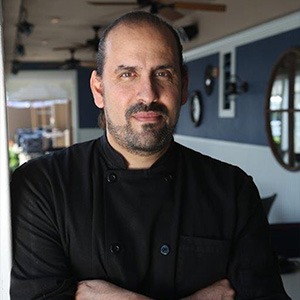 Chef Richard Crespin crossing arms, wearing black chef shirt