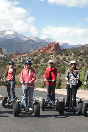 four people on segways at garden of the gods