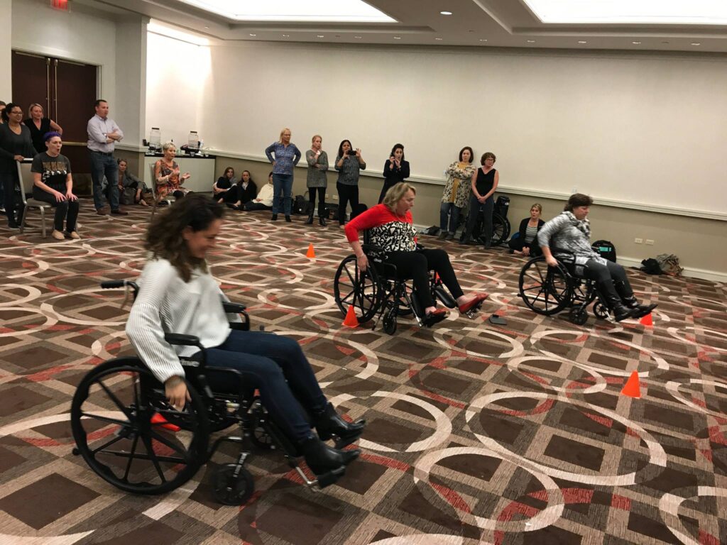 people in wheelchairs in ballroom