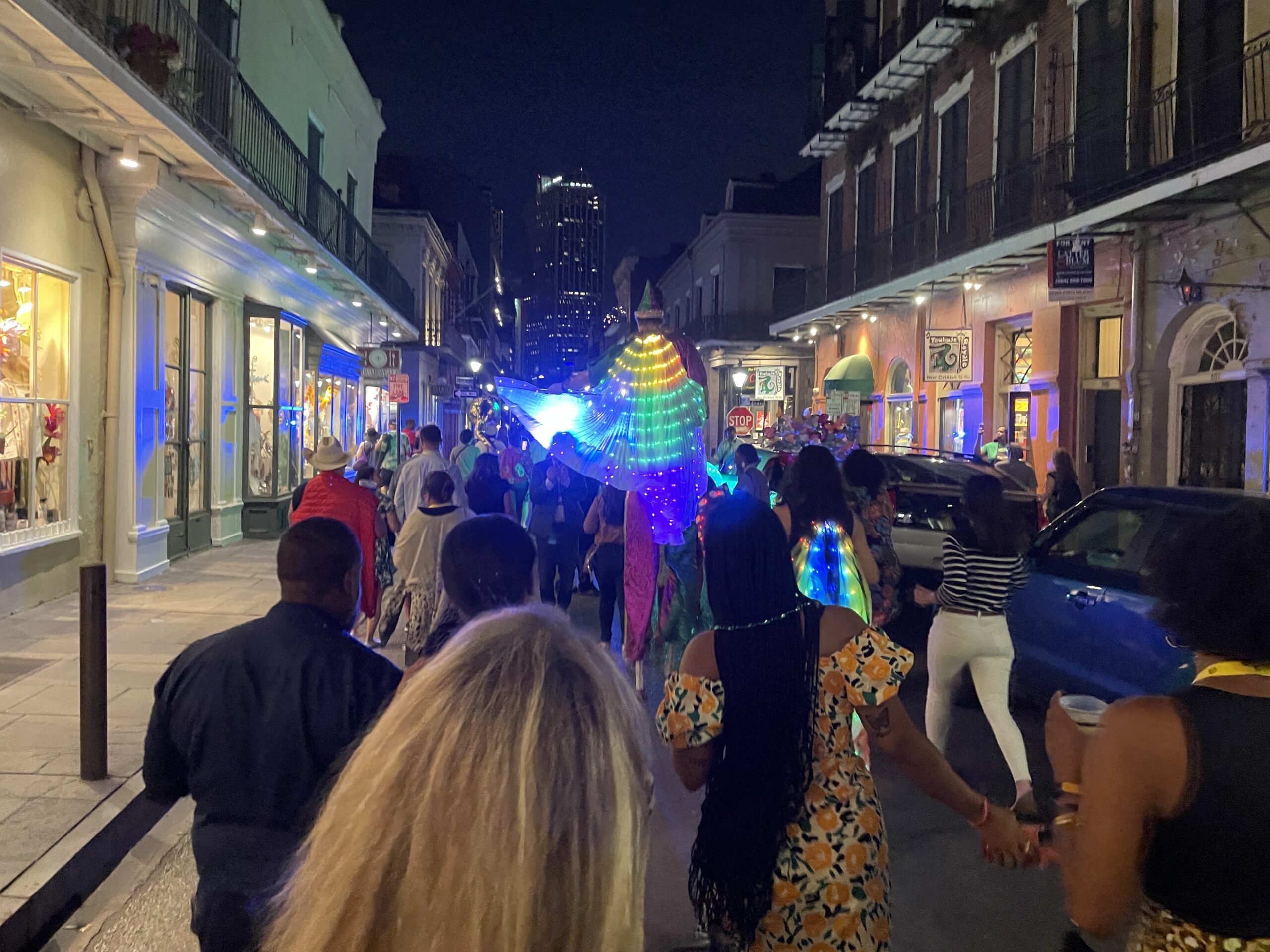 various people on bourbon street led by trumpet players