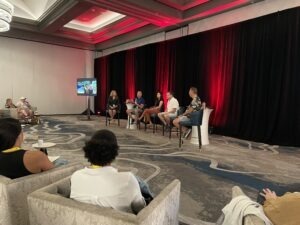 five people on panel at the front of a room