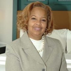 woman wearing light grey suit and white dress shirt