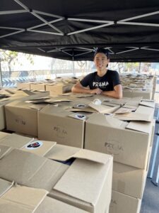 person standing among stacks of boxes