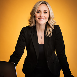 woman wearing black suit in front of yellow background