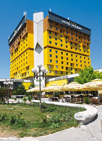 ground floor shot of yellow hotel