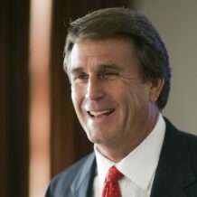man in black suit smiling profile photo