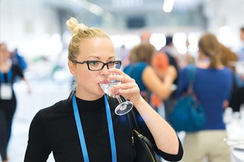 woman drinking from glass of water