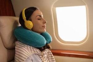 a neck pillow and noise canceling headphones make for an easier air travel experience